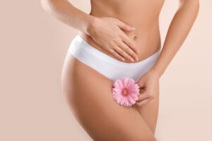 Young woman in white underwear with flower, gynecology concept
