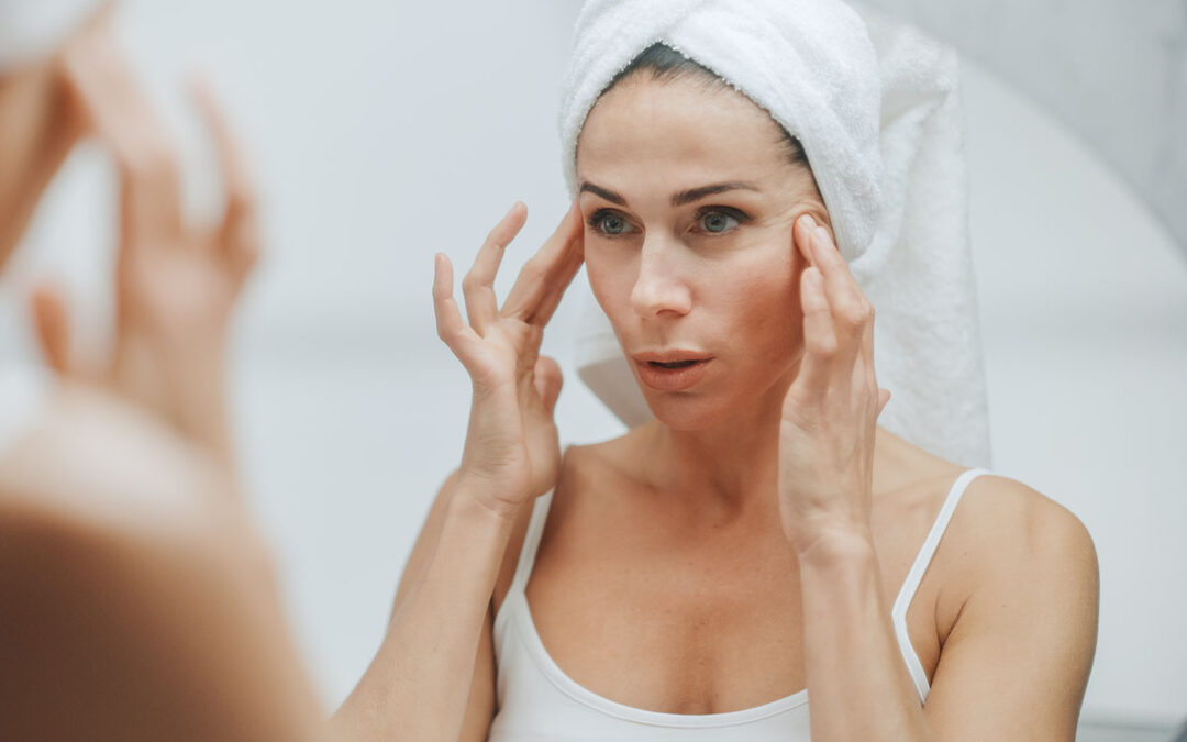 Beautiful caucasian woman touches her perfect face